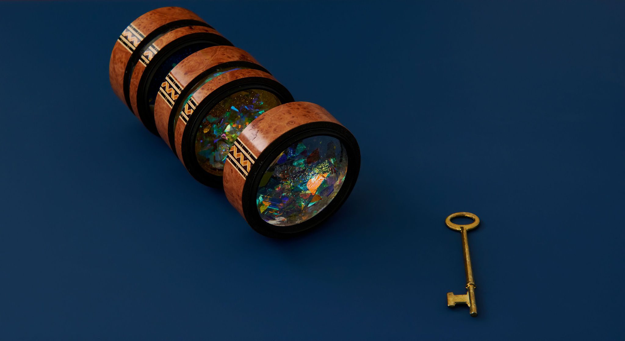 telescope and key on a navy blue background
