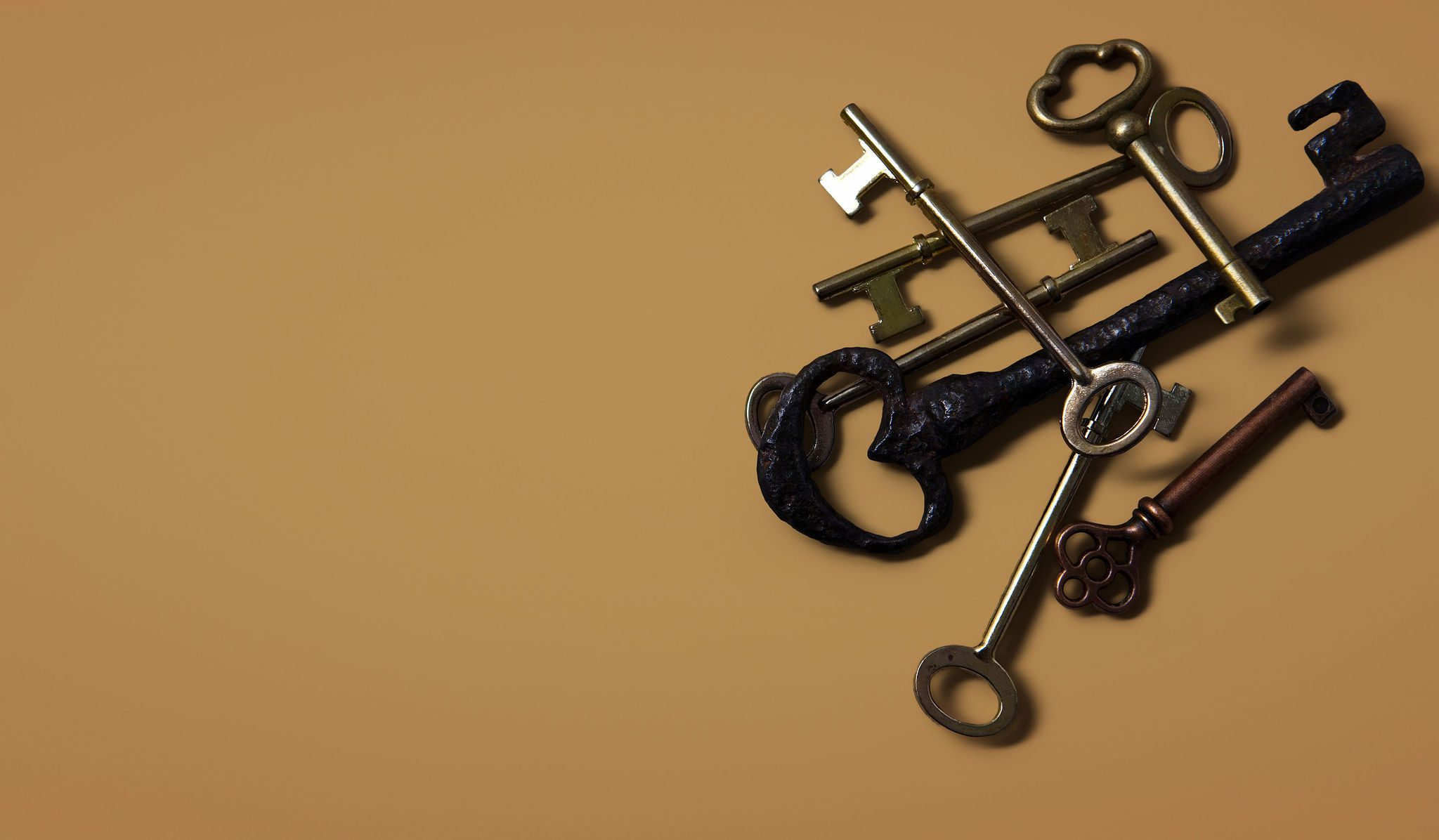 stack of keys on a mustard yellow background | igniting success.com