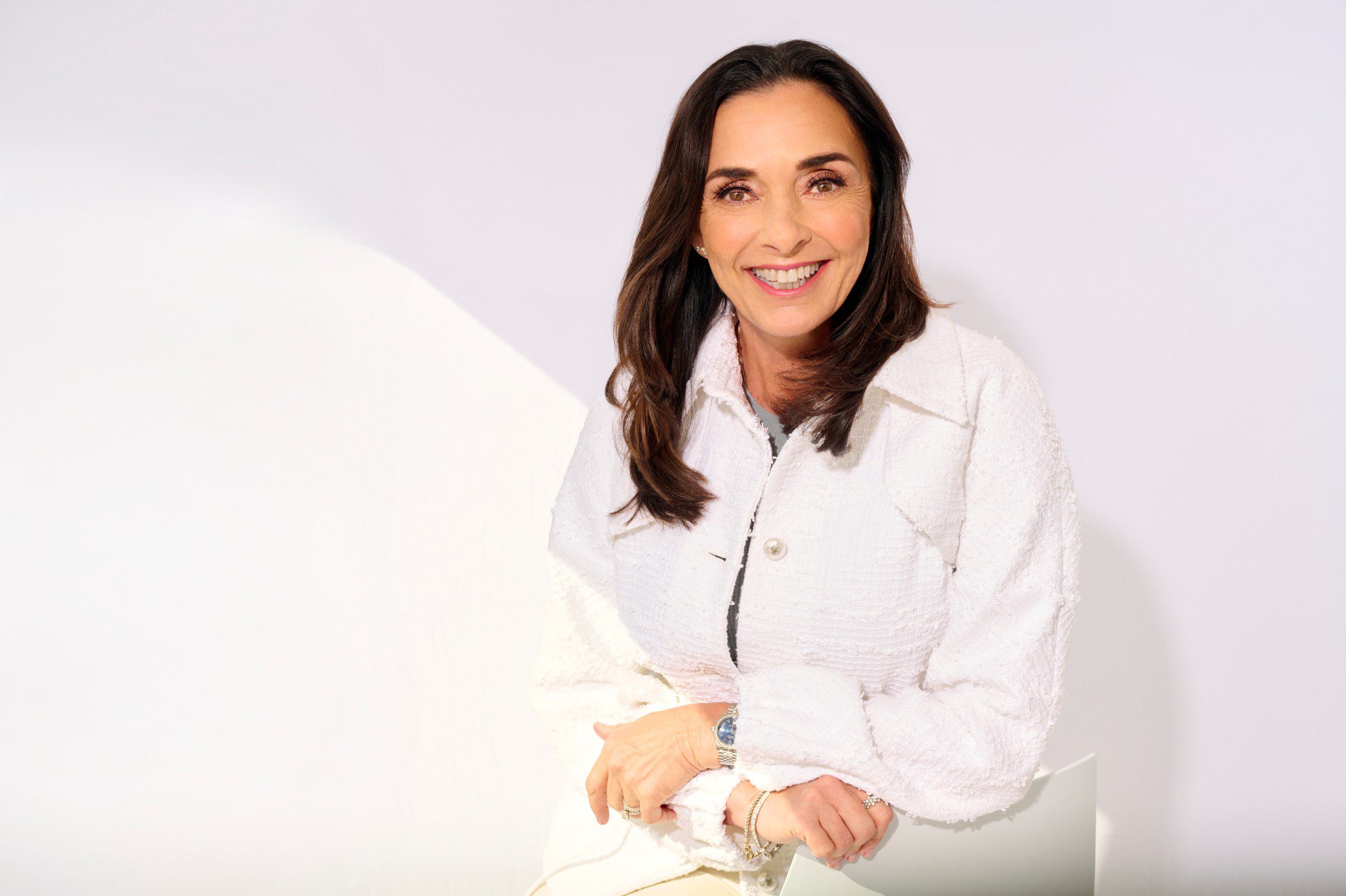 Angela Cusack in a white jacket on a white background